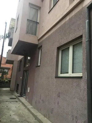 a building with windows on the side of it at Apartmani Milica in Kruševac