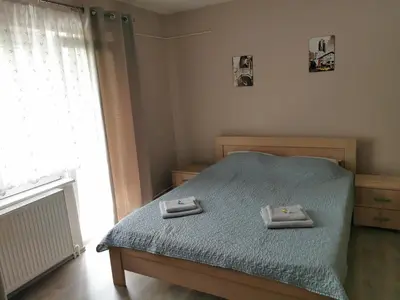a bedroom with a bed with two towels on it at Apartmani Milica in Kruševac