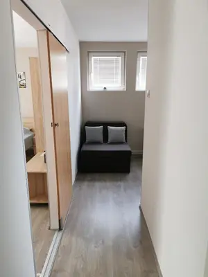 a view of a room with a couch and a mirror at Apartmani Milica in Kruševac