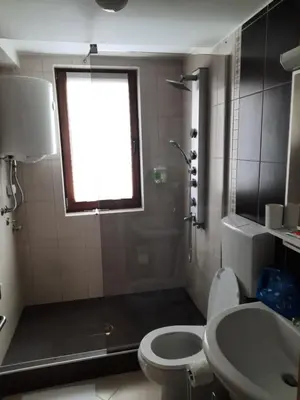a bathroom with a toilet and a sink and a window at Apartman Košuta, Kopaonik in Kopaonik