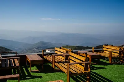 a group of wooden benches sitting on top of a mountain at MISS Premier 19 Milmari in Kopaonik