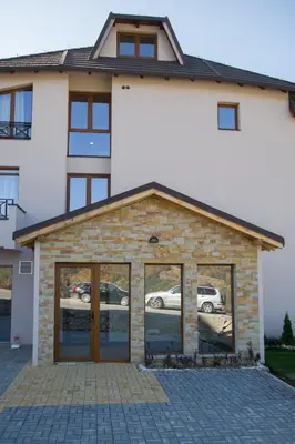 a house with large glass doors in front of it at MISS Premier 19 Milmari in Kopaonik