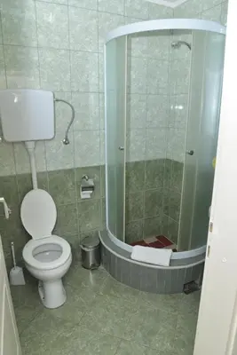 a bathroom with a toilet and a shower at Apartments Imper - IMD in Niš