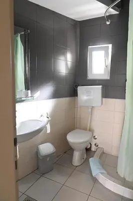 a bathroom with a toilet and a sink at Apartments Imper - IMD in Niš