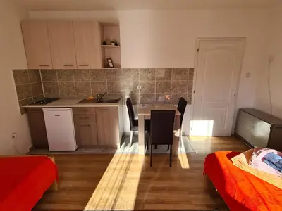 a kitchen and dining room with a table and chairs at Bisa in Soko Banja