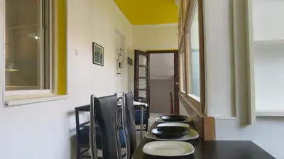 a dining room with a table with black dishes on it at Guest House Pavlovic in Soko Banja