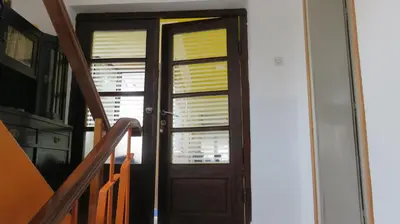 a door with yellow blinds on a stairway at Guest House Pavlovic in Soko Banja