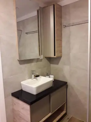 a bathroom with a white sink and a mirror at Apartman Lux Kopaonik in Kopaonik
