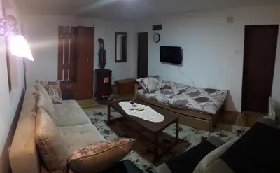 a living room with a couch and a table at Sky in Kopaonik