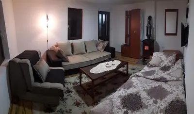 a living room with a couch and a table at Sky in Kopaonik