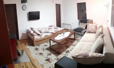 a living room with a couch and a coffee table at Sky in Kopaonik