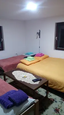 a room with two beds and a table in a room at Sky in Kopaonik