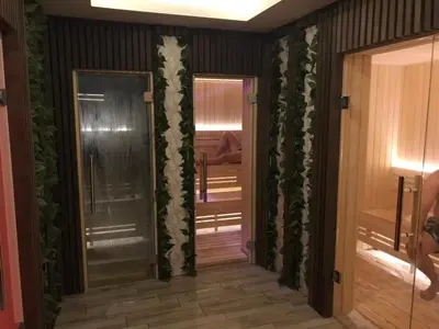 a hallway with a door with plants on the walls at Apartman Lux Premier 09 Kopaonik in Kopaonik