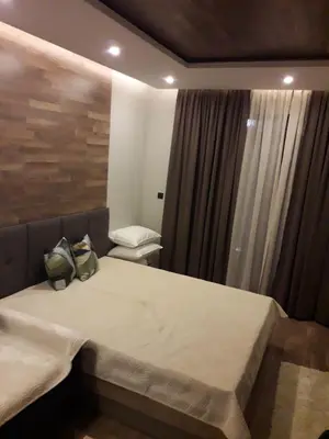 a bedroom with a bed with a bag on it at Apartman Lux Premier 09 Kopaonik in Kopaonik