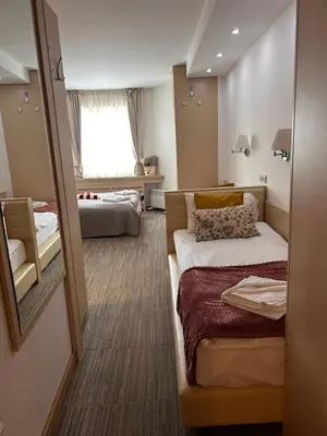 a hotel room with a bed and a mirror at Tri-M Konaci in Kopaonik