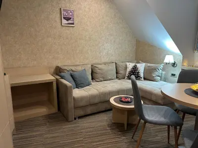 a living room with a couch and a table at Tri-M Konaci in Kopaonik