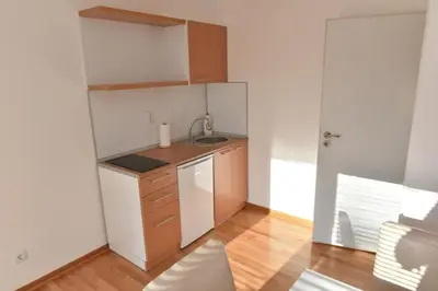 a small kitchen with a sink and a counter at Promenada apartmani in Kruševac