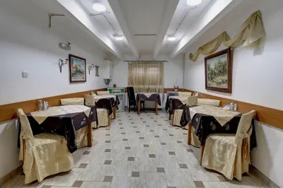 a restaurant with tables and chairs in a room at PERLA Leskovac in Leskovac