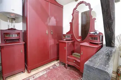 a red bathroom with a mirror and red cabinets at PERLA Leskovac in Leskovac