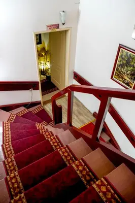 a room with a staircase and a stair case with a stair case at PERLA Leskovac in Leskovac