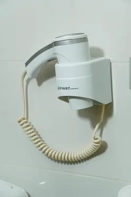 a phone hanging on a wall in a bathroom at Wonderland spa apartment in Niš