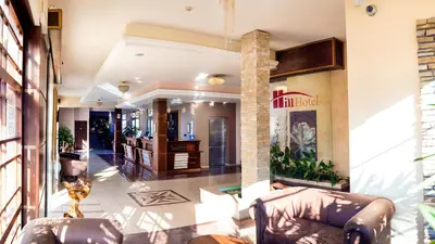 a lobby of a building with two couches at Hill Wellness & Spa in Jagodina