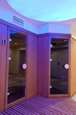a hallway with two glass doors in a building at Hill Wellness & Spa in Jagodina