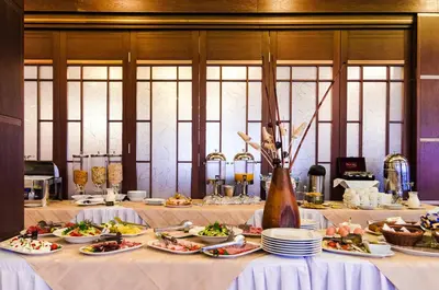 a table with plates of food on it at Hill Wellness & Spa in Jagodina