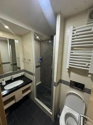 a bathroom with a shower and a toilet and a sink at Apartments Konaci Kopaonik in Kopaonik