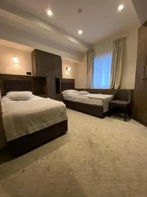 a hotel room with two beds and a window at Apartments Konaci Kopaonik in Kopaonik