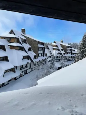 a resort in the snow with snow covered buildings at Apartments Konaci Kopaonik in Kopaonik