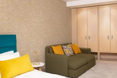 a living room with a couch and a cabinet at Neva Apartment Angella Konaci in Kopaonik
