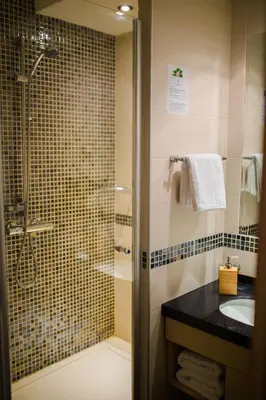 a bathroom with a glass shower and a sink at Neva Apartment Angella Konaci in Kopaonik