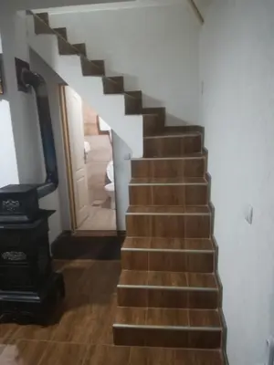 a stairway leading to a hallway with a stair case at Etno selo Vile Jefimija, selo Preobrazenje, Vranje in Vranje