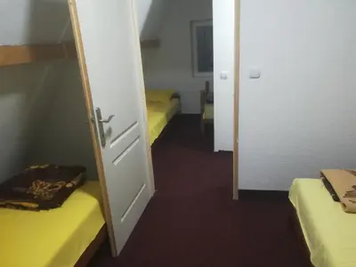 a room with two beds and a door open at Etno selo Vile Jefimija, selo Preobrazenje, Vranje in Vranje