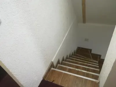 a staircase in a room with a white wall at Etno selo Vile Jefimija, selo Preobrazenje, Vranje in Vranje