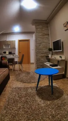 a living room with a blue table in a living room at Sky apartments Kopaonik in Kopaonik