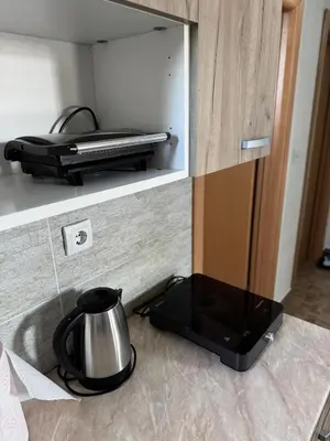 a kitchen counter with a tea kettle on a stove at Sky apartments Kopaonik in Kopaonik
