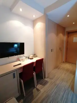 a room with a desk with chairs and a television at Kopaonik011 Konaci&WoodSide Apartments in Kopaonik