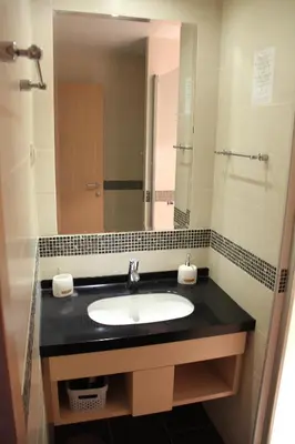 a bathroom with a sink and a large mirror at Kopaonik011 Konaci&WoodSide Apartments in Kopaonik