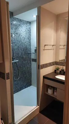 a bathroom with a glass shower and a sink at Sweet Home Konaci in Kopaonik