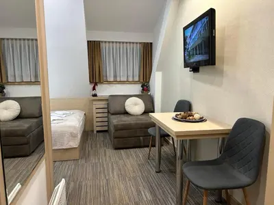 a small living room with a couch and a television at Sweet Home Konaci in Kopaonik
