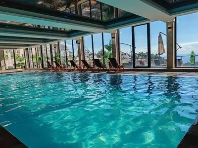 a swimming pool with chairs in a building at Ski&Spa Milmari L17 in Kopaonik