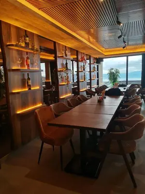 a dining room with a large wooden table and chairs at Ski&Spa Milmari L17 in Kopaonik
