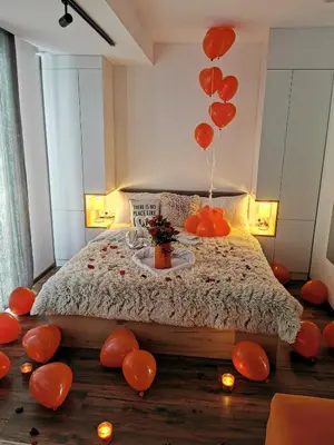 a room with a bed with red balloons and candles at Apartmani TIM & SPA CENTAR in Kopaonik