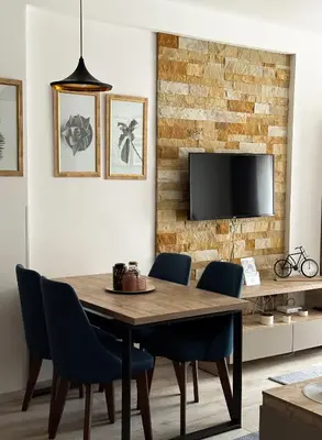 a dining room with a table and chairs and a tv at Queen of Kop Milmari in Kopaonik