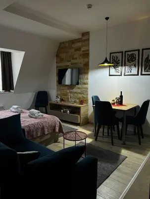 a living room with a bed and a table and chairs at Queen of Kop Milmari in Kopaonik
