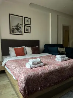 a bedroom with a large bed with two towels on it at Queen of Kop Milmari in Kopaonik
