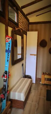 a room with a bed and a door and a skis at Uki & Sofi mountain house in Kopaonik