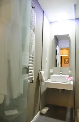 a bathroom with a sink and a mirror at Hotel Sole in Niš